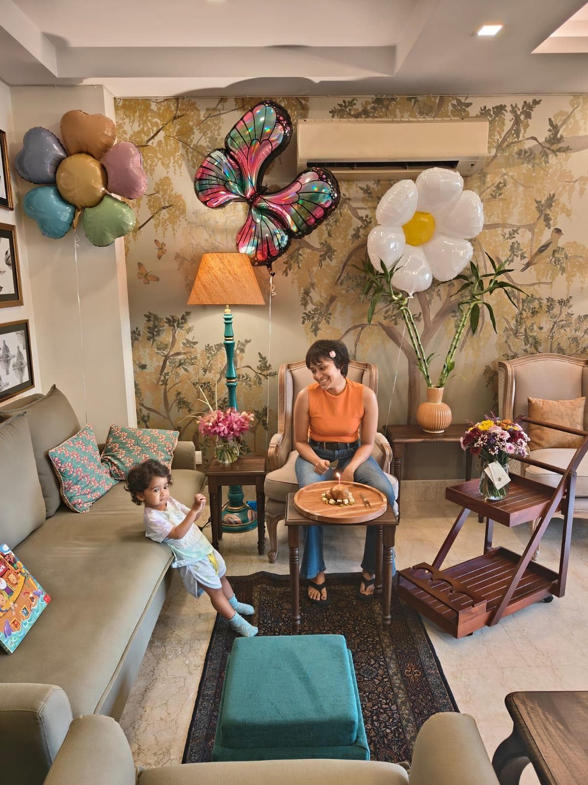 Ruchi at home in her living room with her child